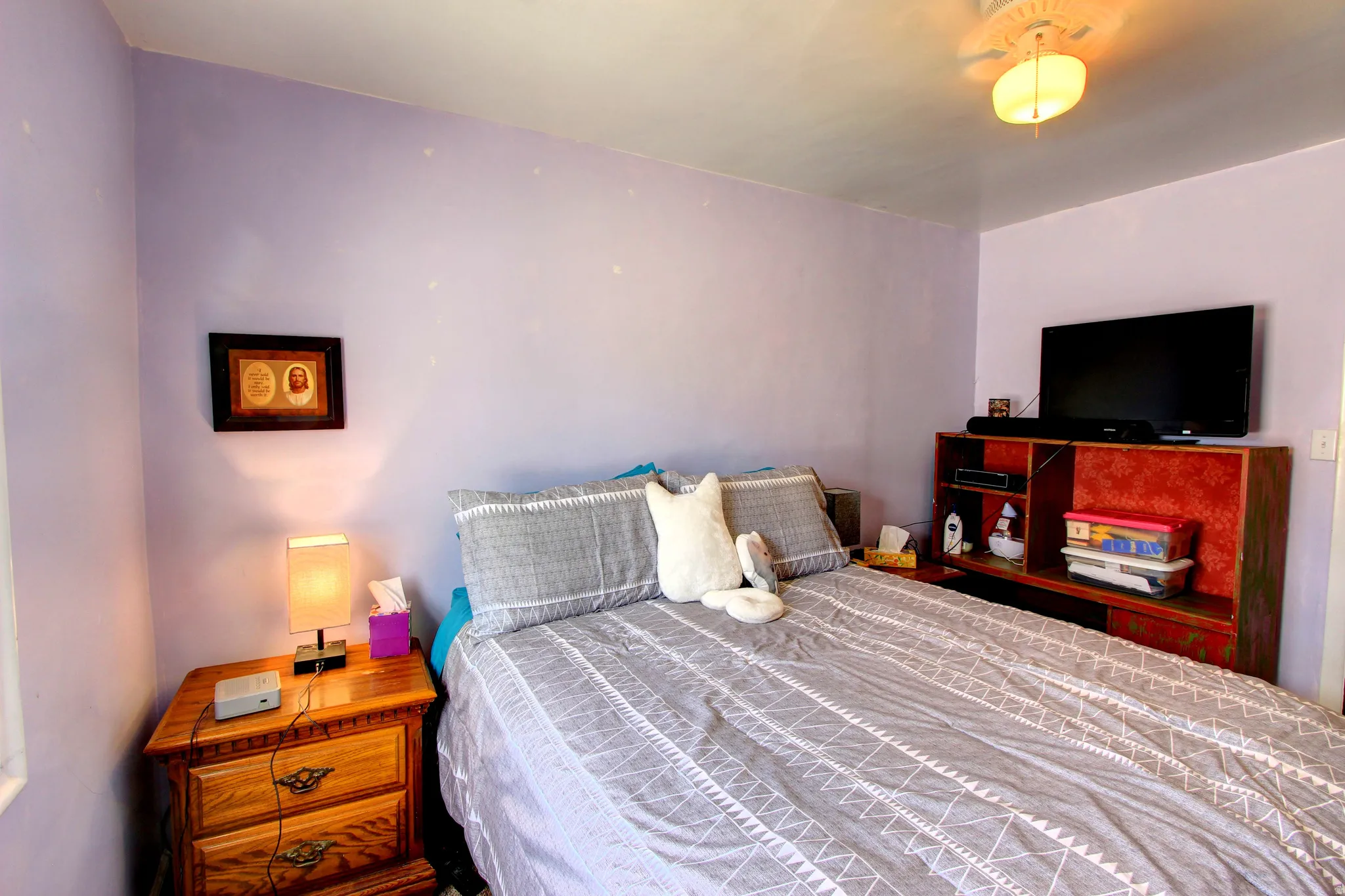 Room featuring a ceiling fan, light purple wall color, and white ceiling