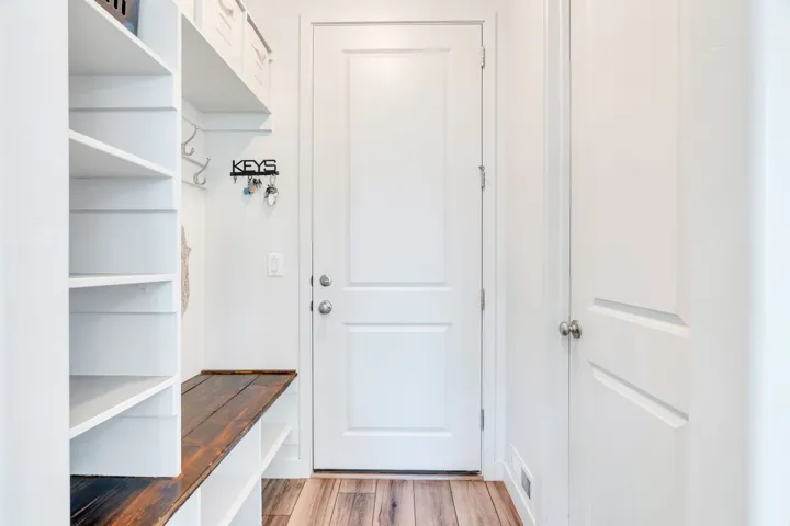 Built in shelving, bench, and hooks in mud room