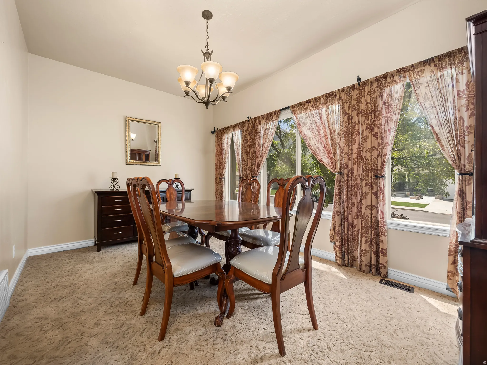 Dining area featuring patterned carpet and multiple windows