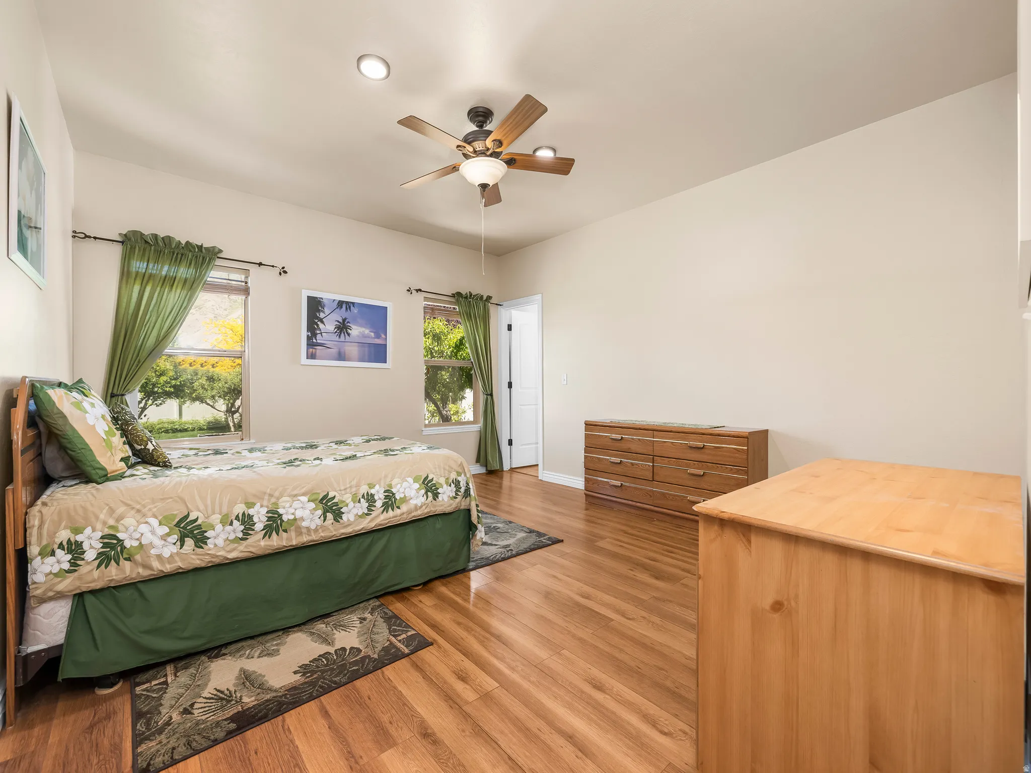 Bright interior space featuring wood-finish flooring and a vaulted ceiling