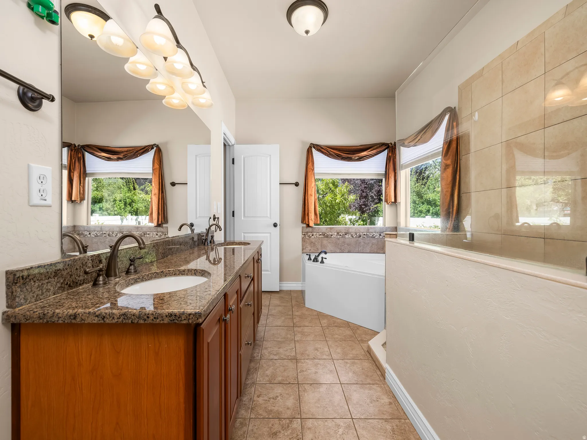 Double vanity with integrated sinks and a stone-finish countertop