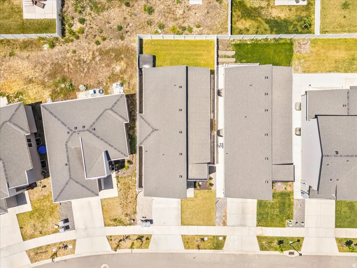 Aerial perspective showcasing multiple residential properties with grey shingle roofs