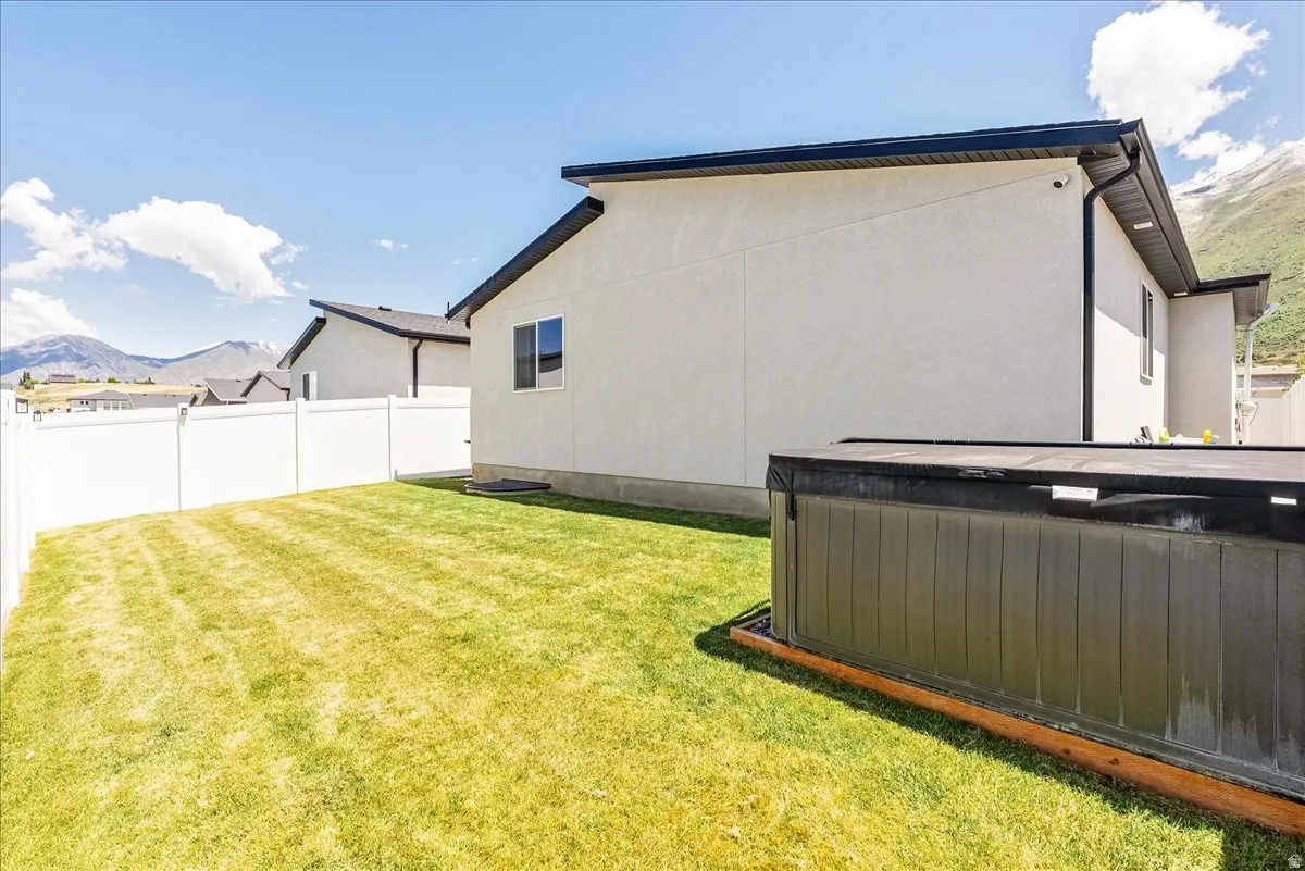 Manicured lawn framed by a white privacy fence