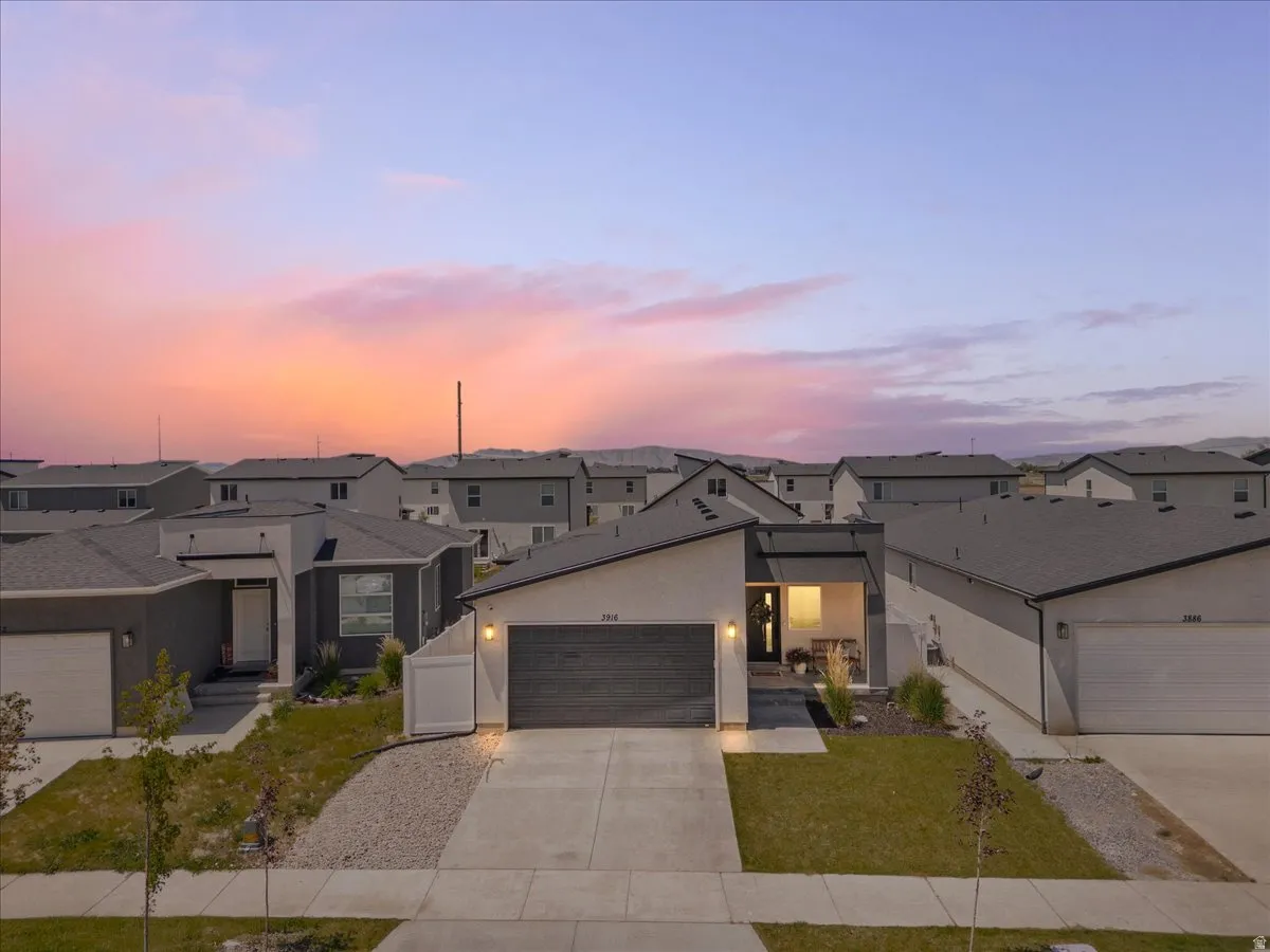 Contemporary single-story residence featuring a dark gray exterior with white trim