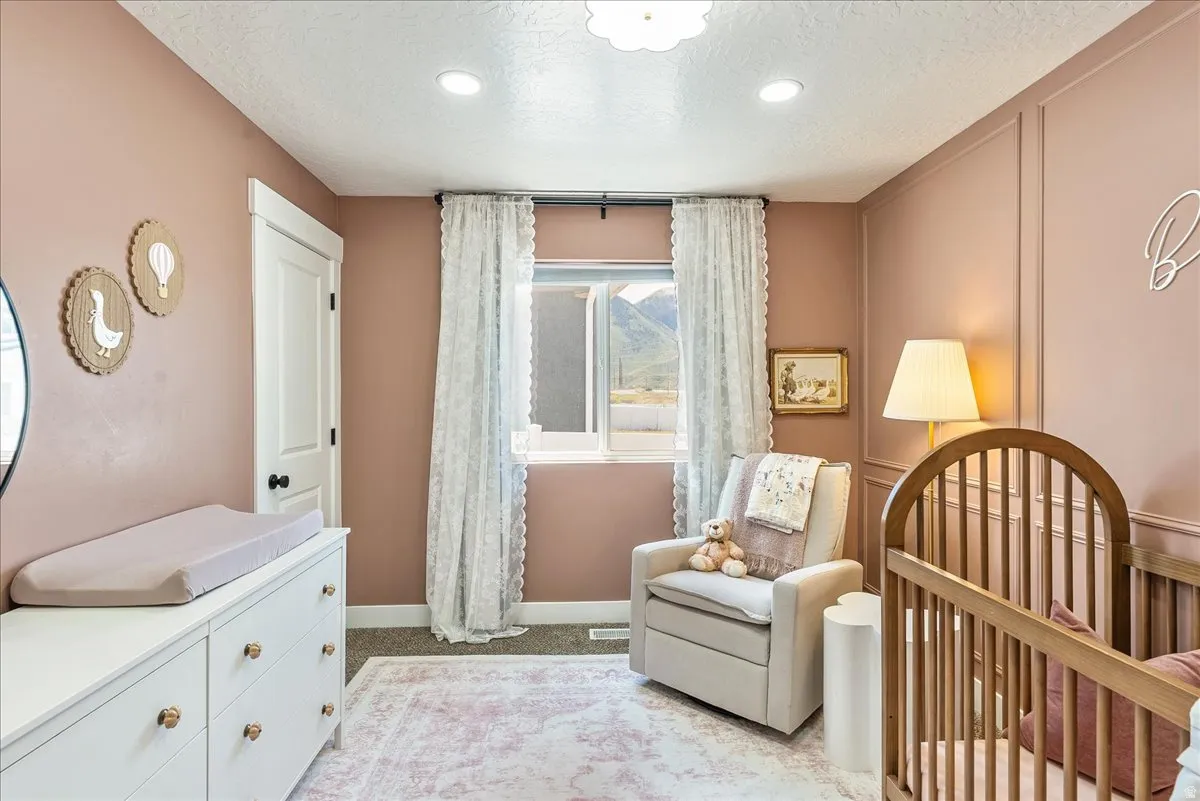 Room featuring recessed lighting, a window with mountain scenery, and carpet flooring