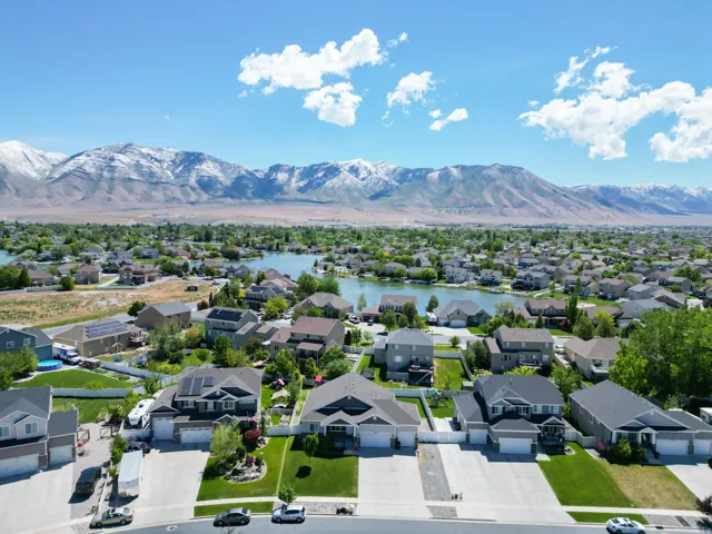 Aerial community perspective featuring a central lake and surrounding residential properties
