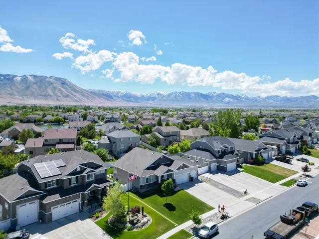 Suburban neighborhood featuring a variety of residential properties, multiple garages, and paved driveways