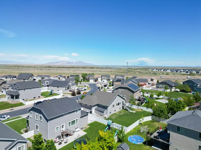 Aerial perspective showcasing a residential neighborhood with distant mountains