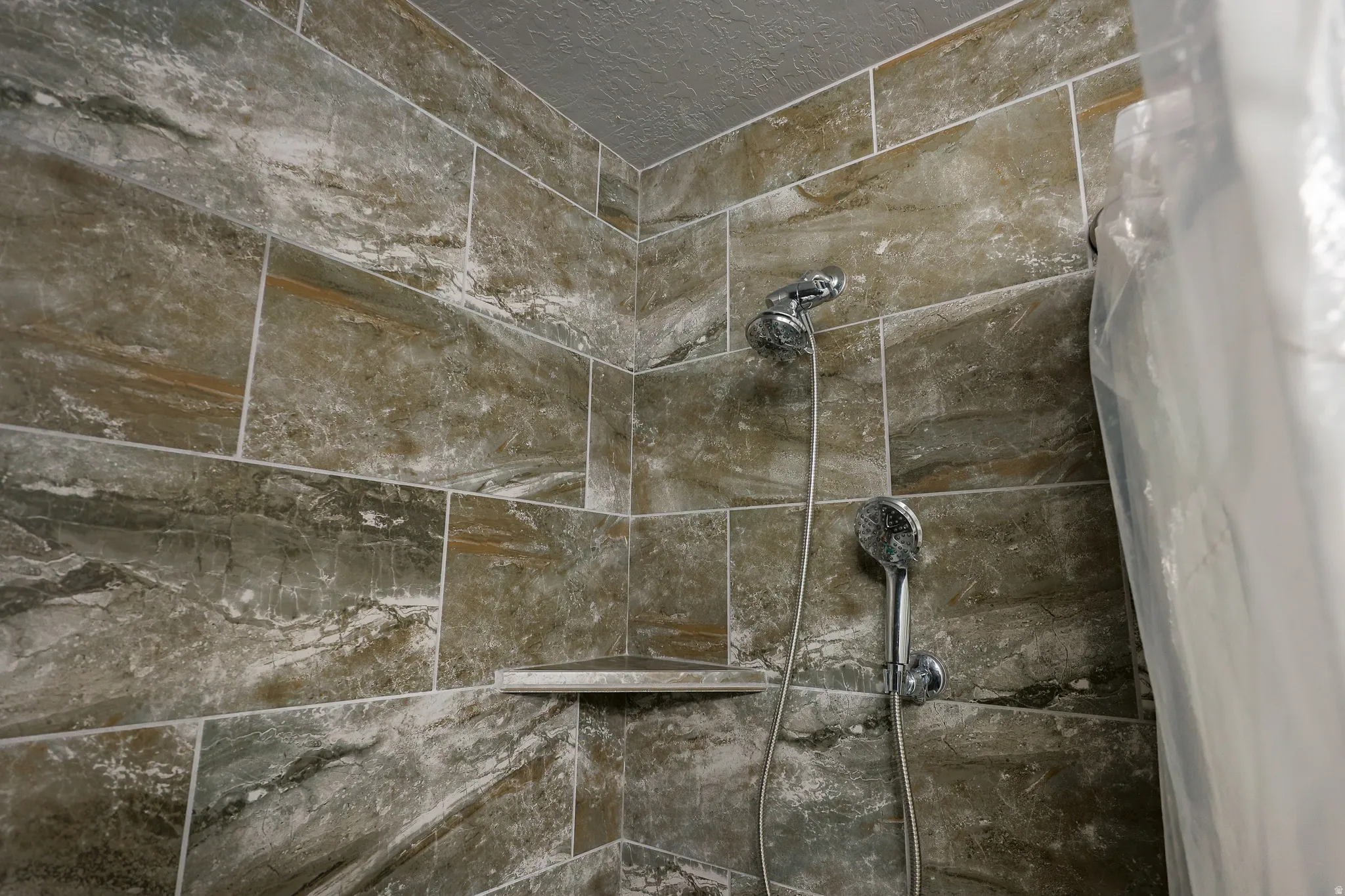 Upgraded tile in Primary Bathroom, full surround