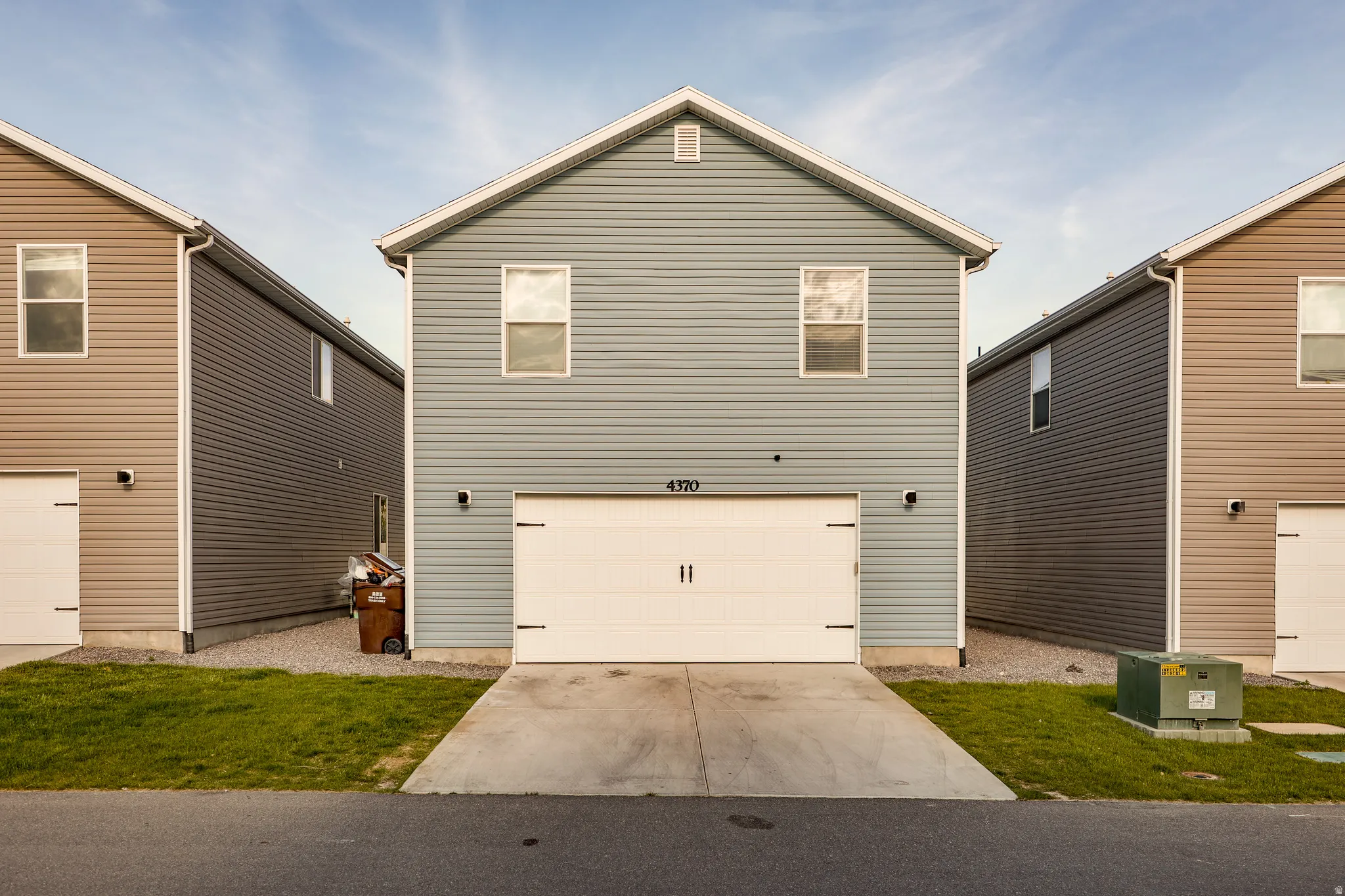 Extra wide garage with charming garage door.