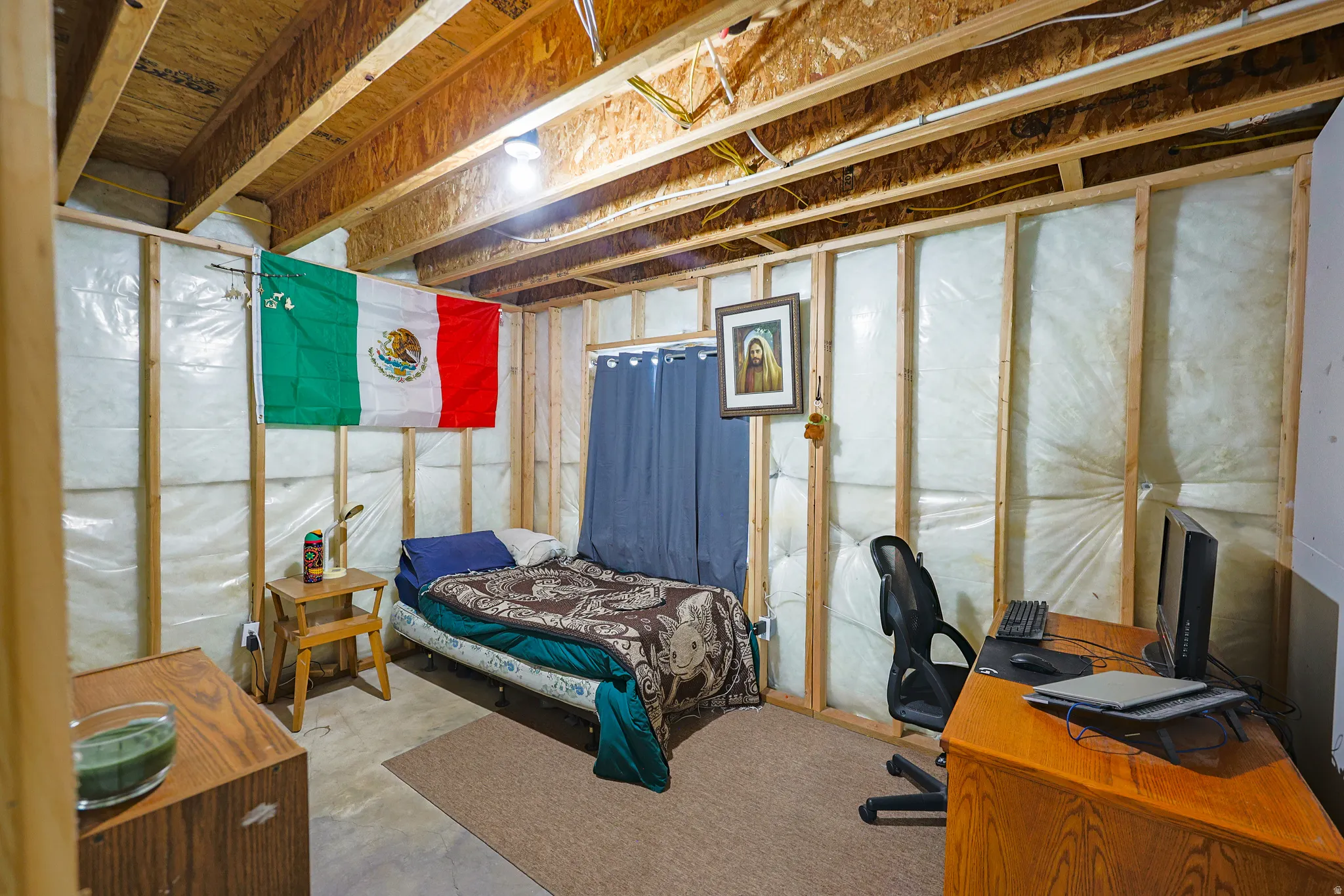 Parcially finished bedroom with some drywall and electricity.