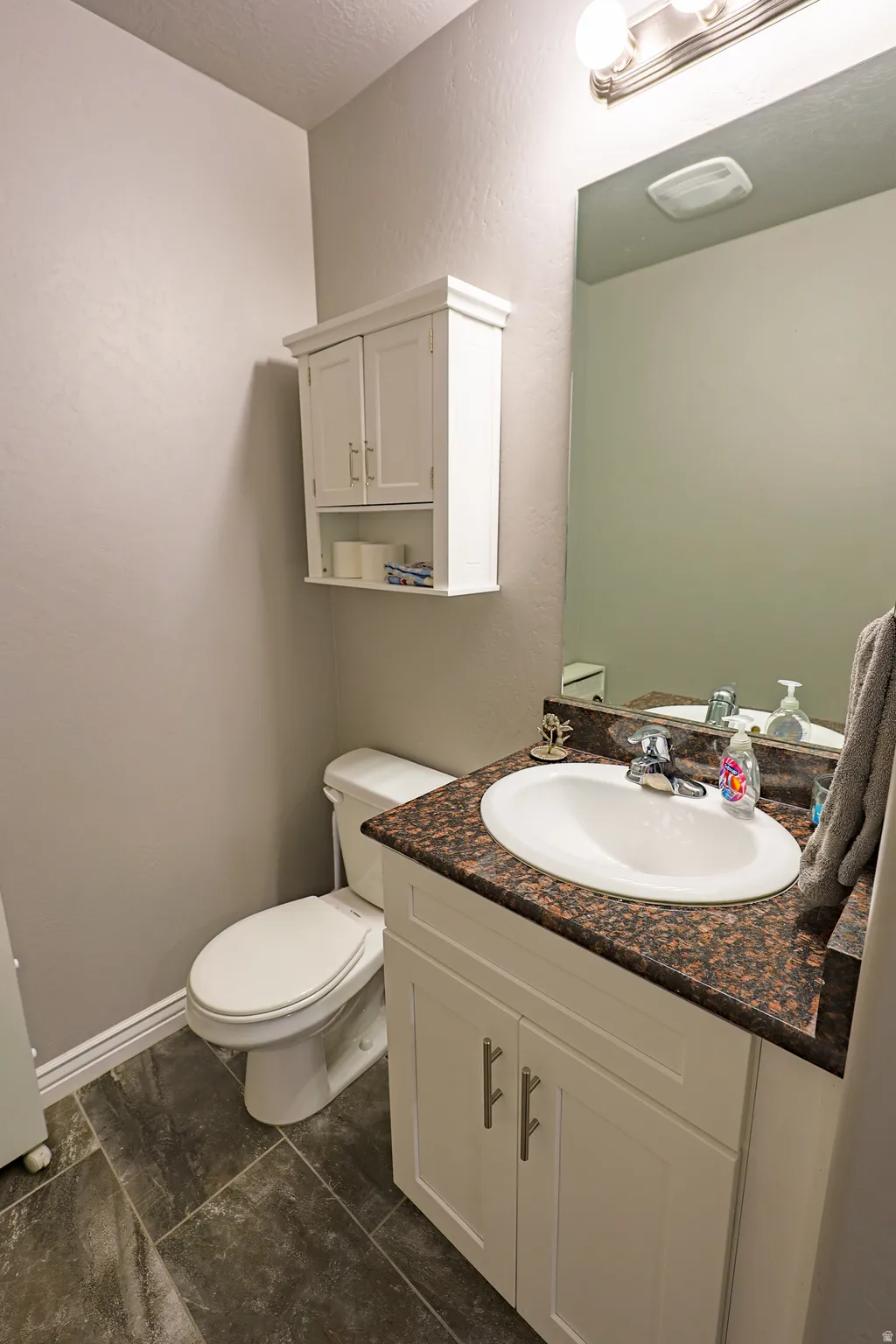 Half bathroom with granite counter top on main level. Convenient