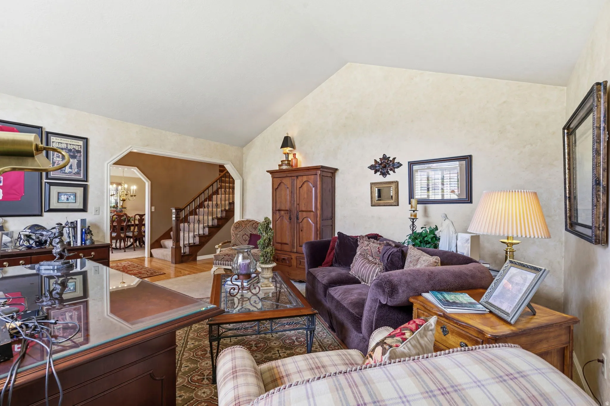 Vaulted ceilings enhance this living space featuring textured walls