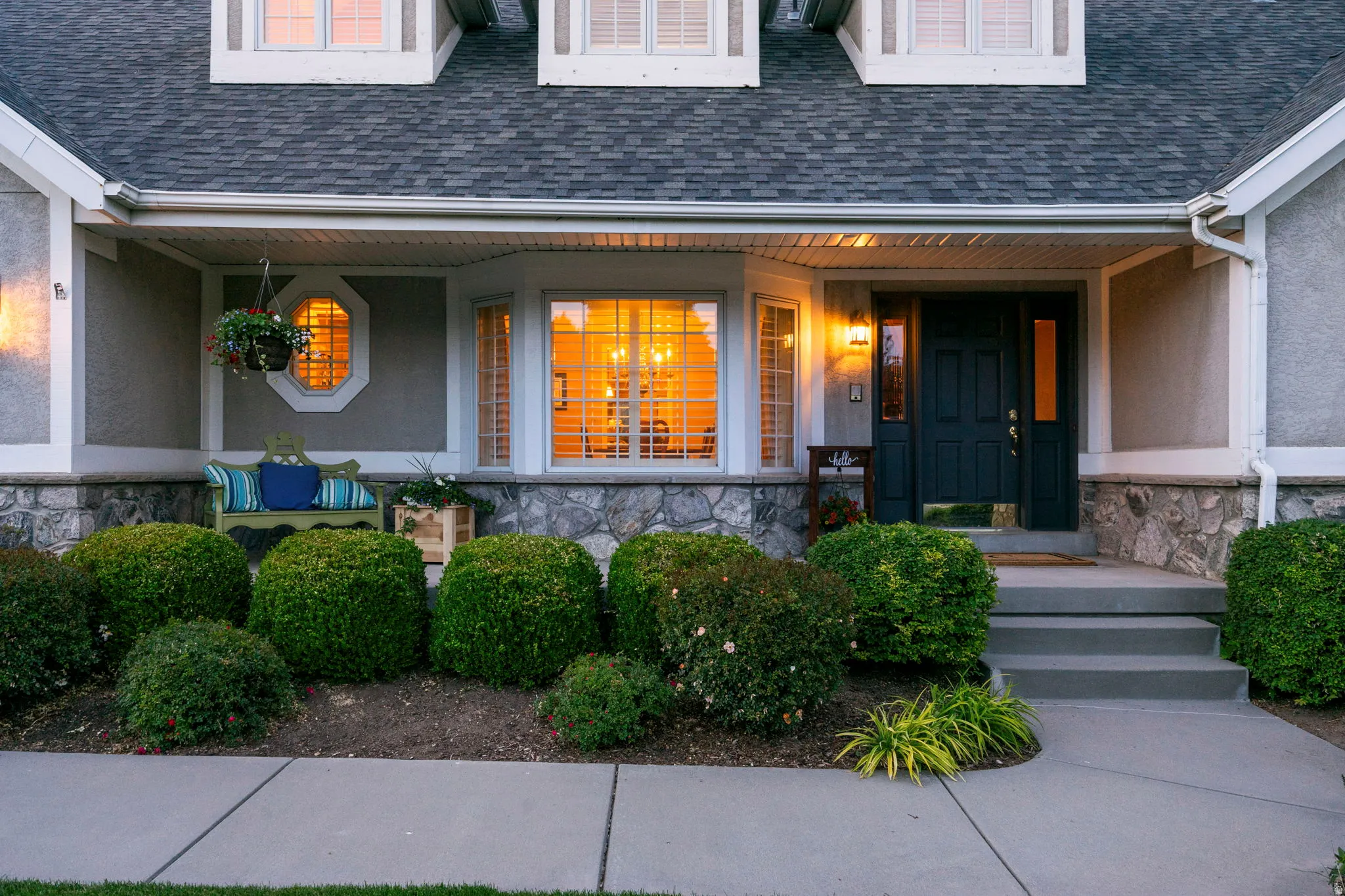 Inviting front entry featuring a dark paneled door, decorative sidelights, and an overhead porch light