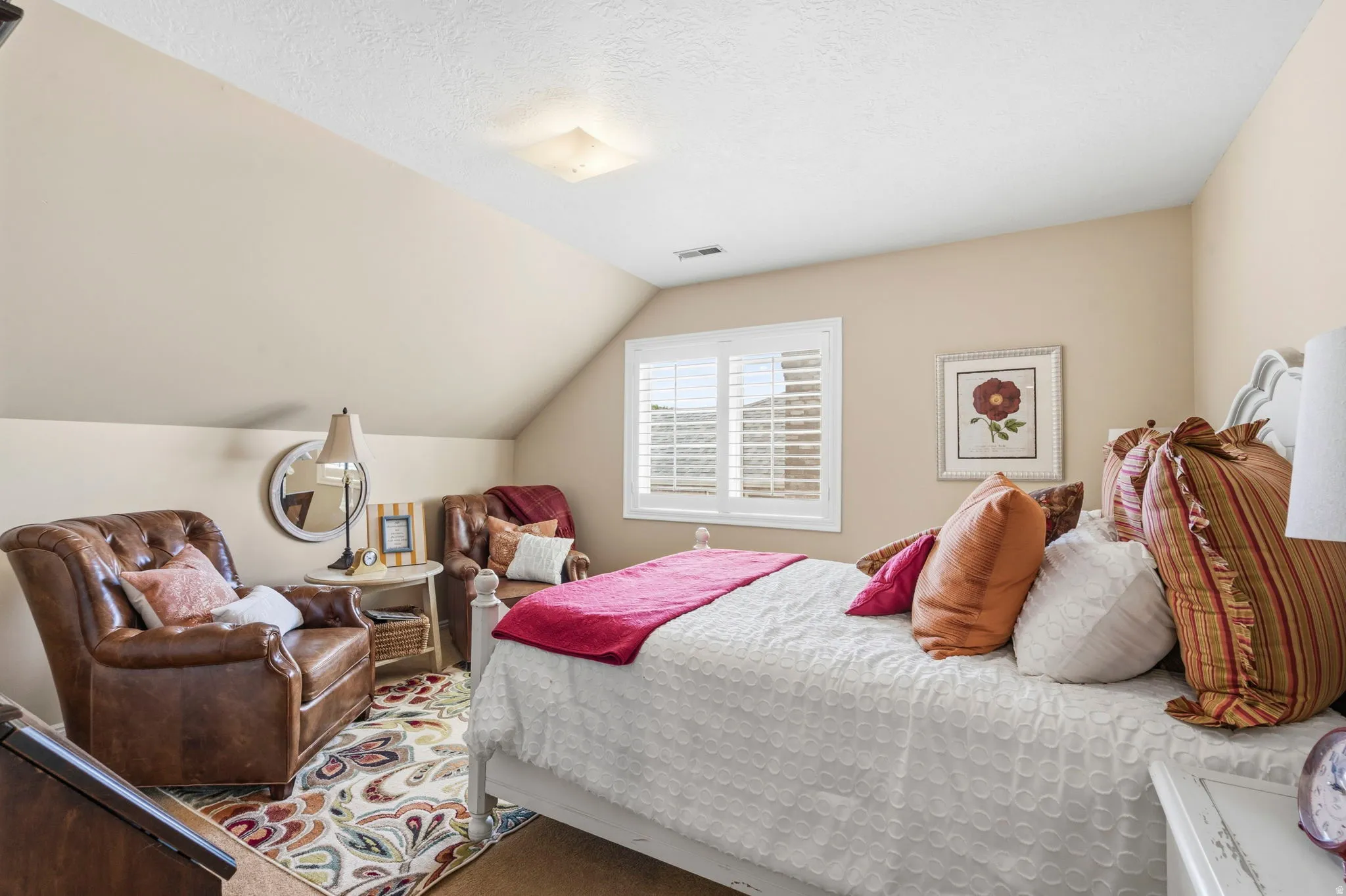 Room with sloped ceilings and light beige walls