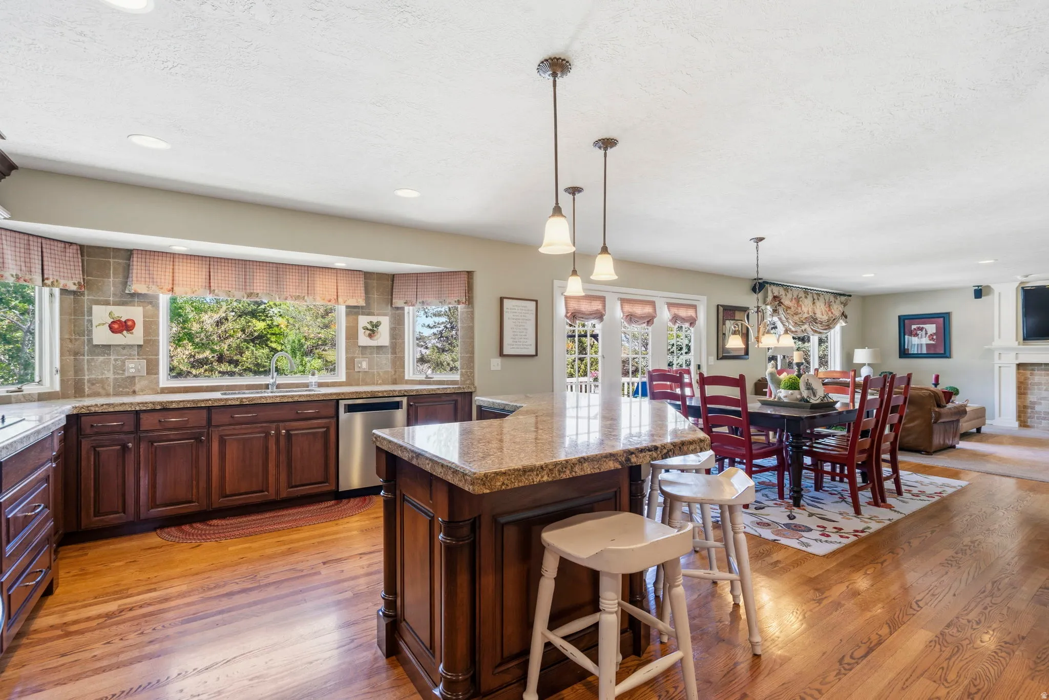 Kitchen featuring a central island, wood-finish flooring, recessed lighting, and granite countertops