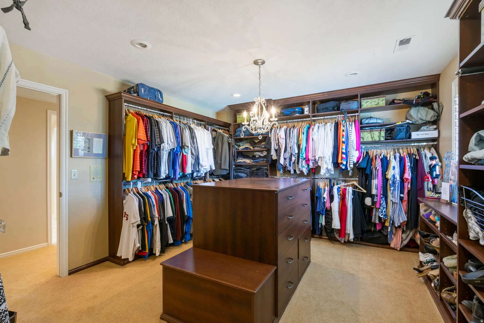 Custom closet system featuring extensive shelving and hanging rods