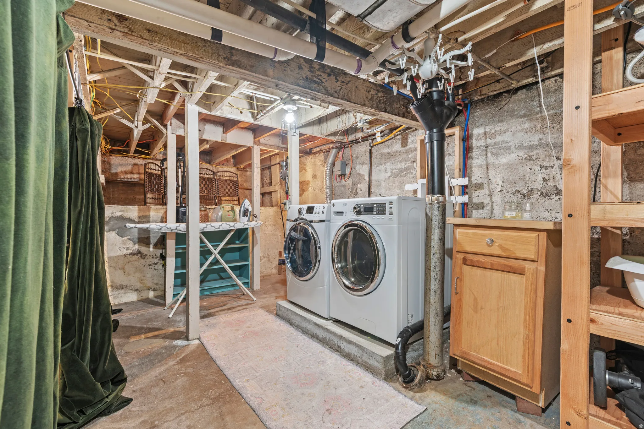 Laundry area withincluded washer and dryer with ample storage space