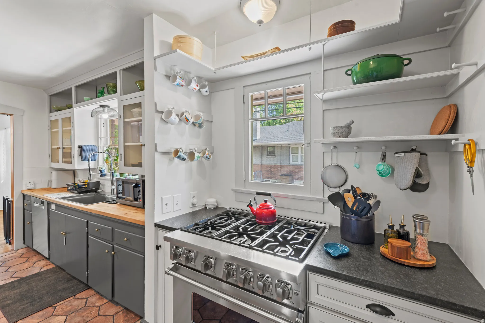 Gourmet kitchen featuring a six burner Viking range and open shelving