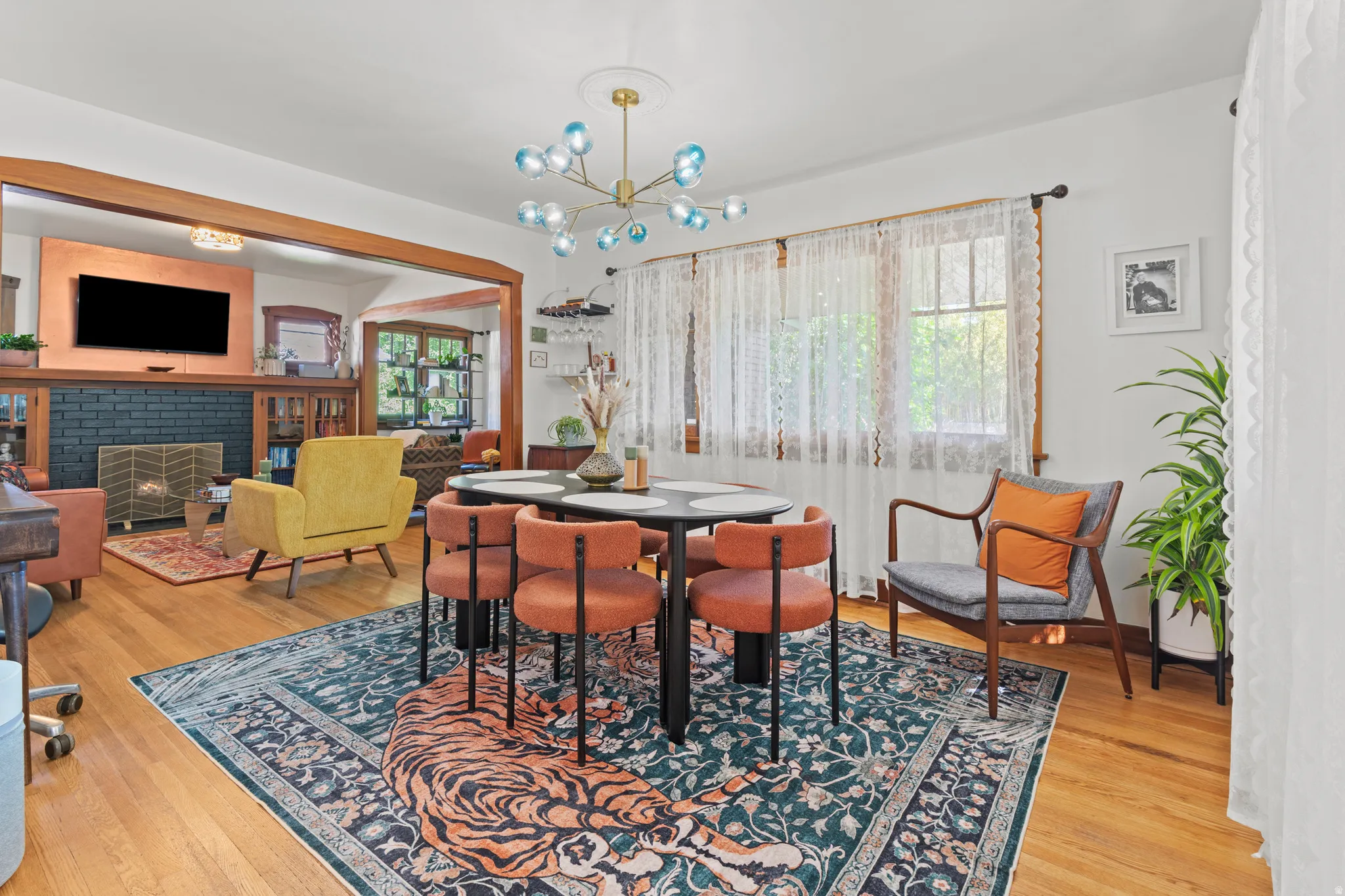Dining area with generous space and light, with a unique light fixture