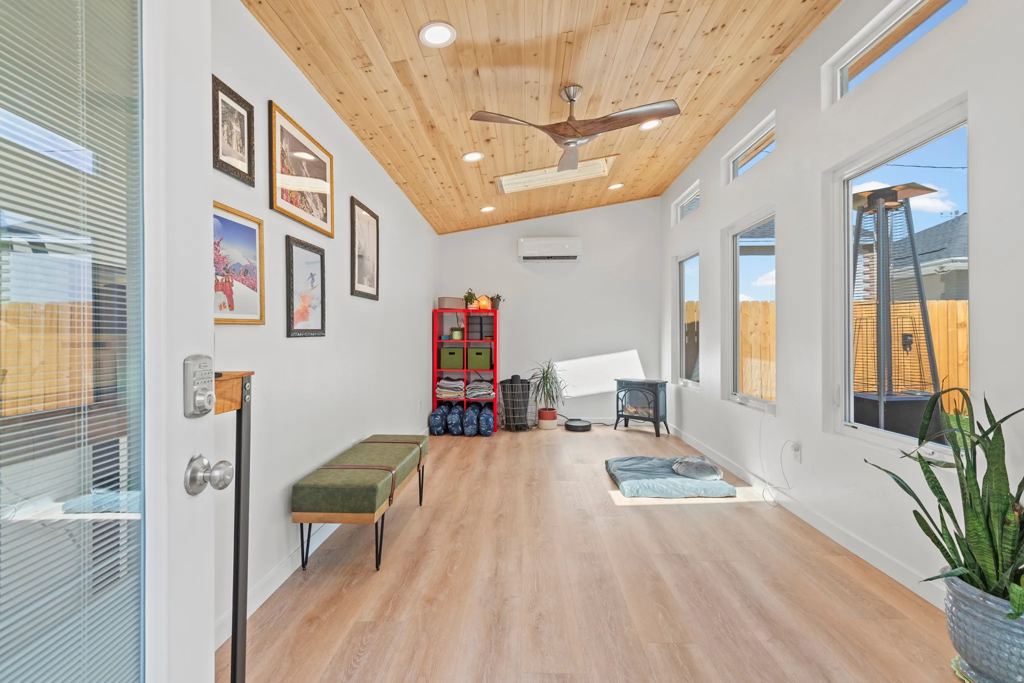 Vaulted wood ceiling in a separate studio space with recessed lighting, ceiling fan, and mini split for comfort.