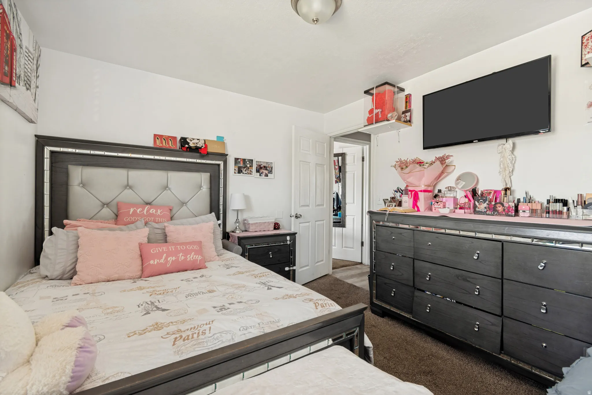 Bedroom featuring wood-finish flooring, white walls, and a ceiling-mounted light fixture
