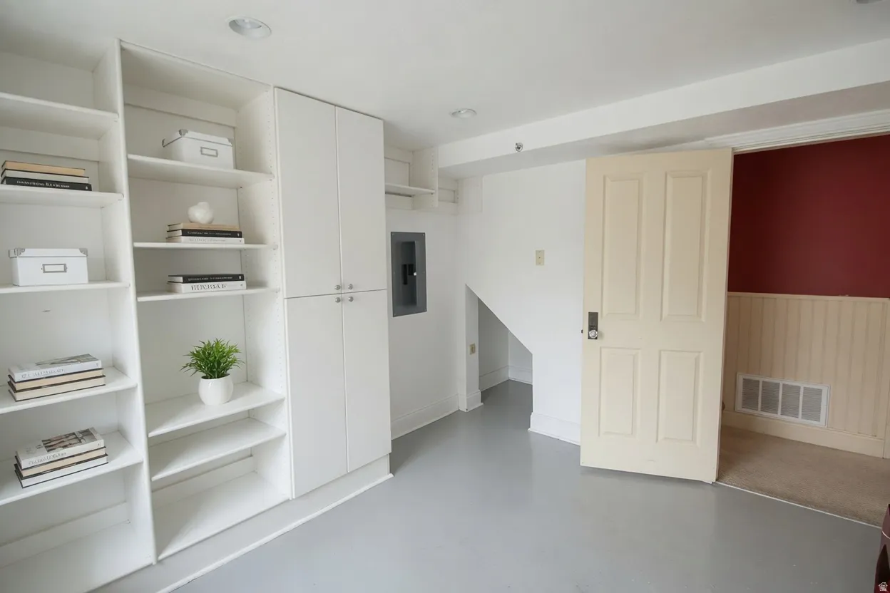 Built-in white cabinetry and shelving units provide extensive storage