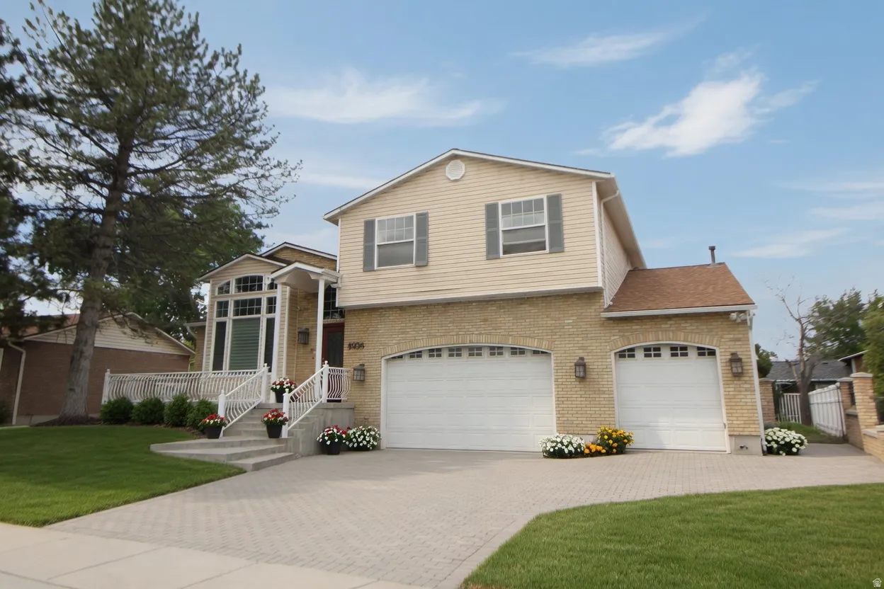 Two-story residence featuring a brick and siding exterior
