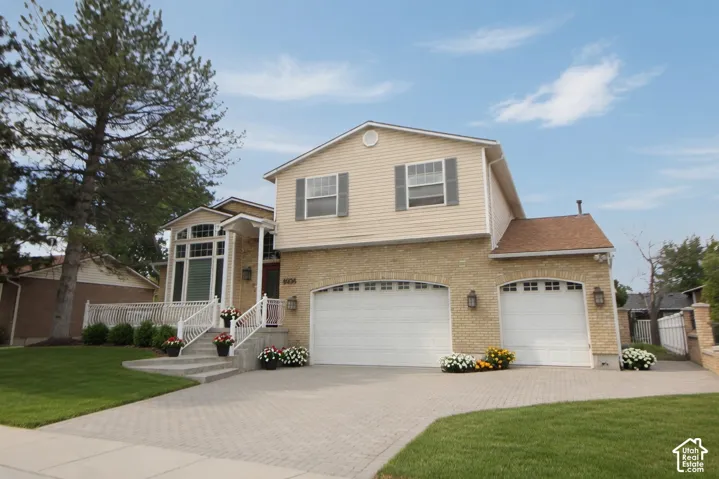 Two-story residence featuring a brick and siding exterior