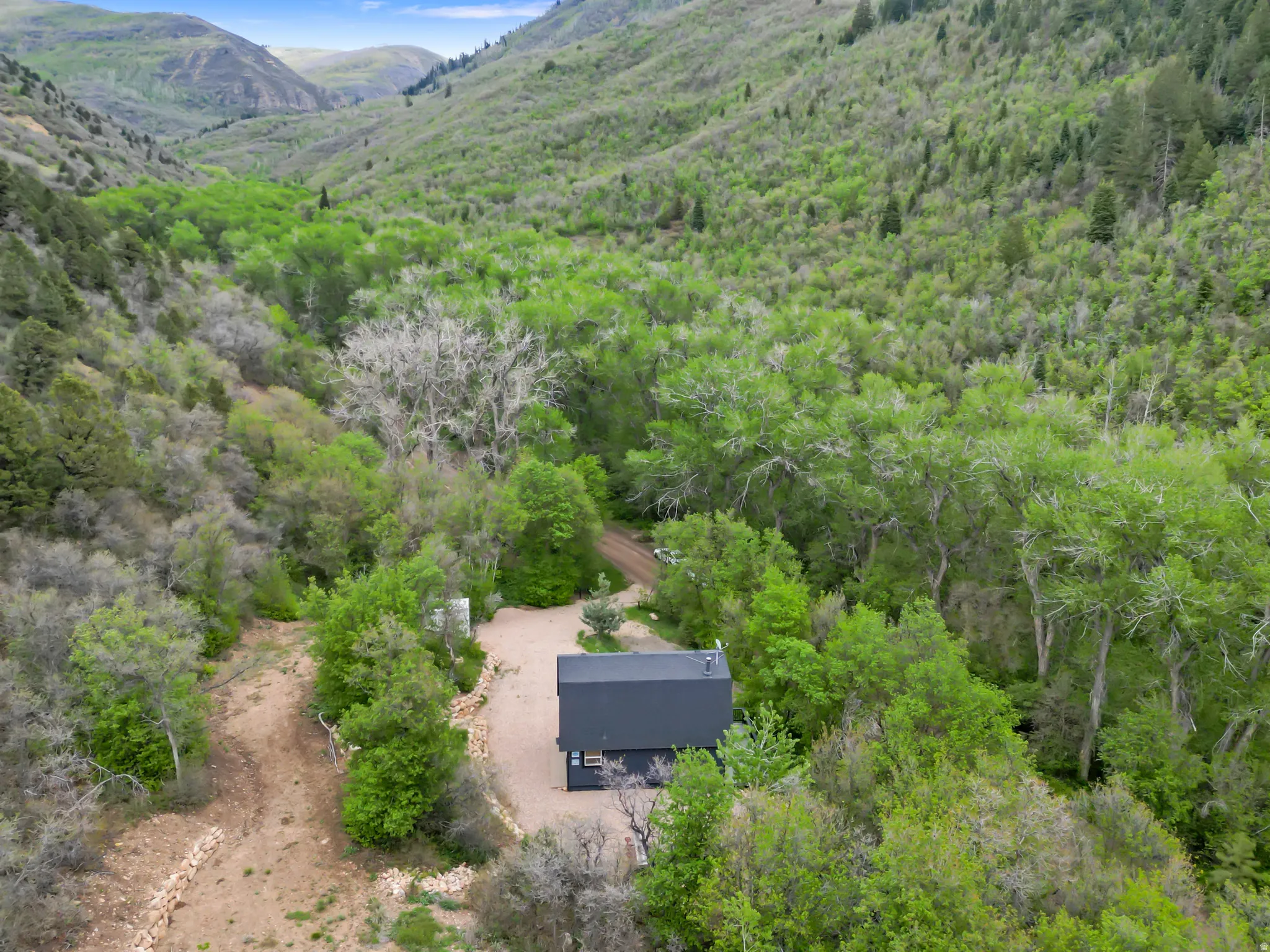 Compact modern structure nestled within a verdant mountain valley