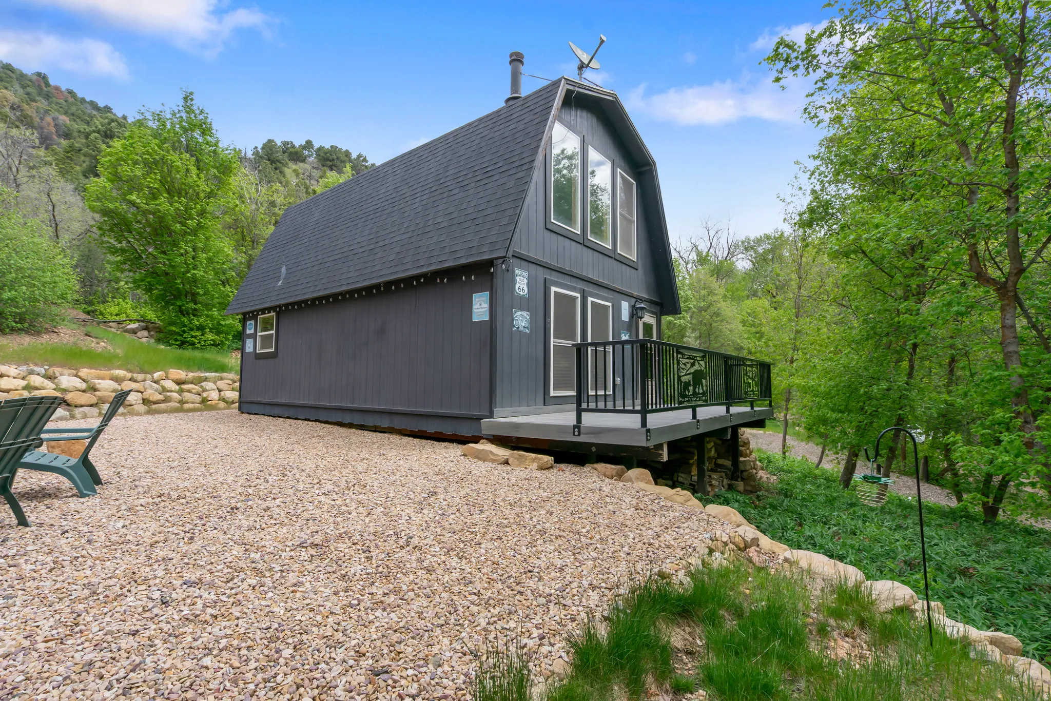 Barn-style exterior featuring dark siding, a gabled roof, and multiple upper-level windows