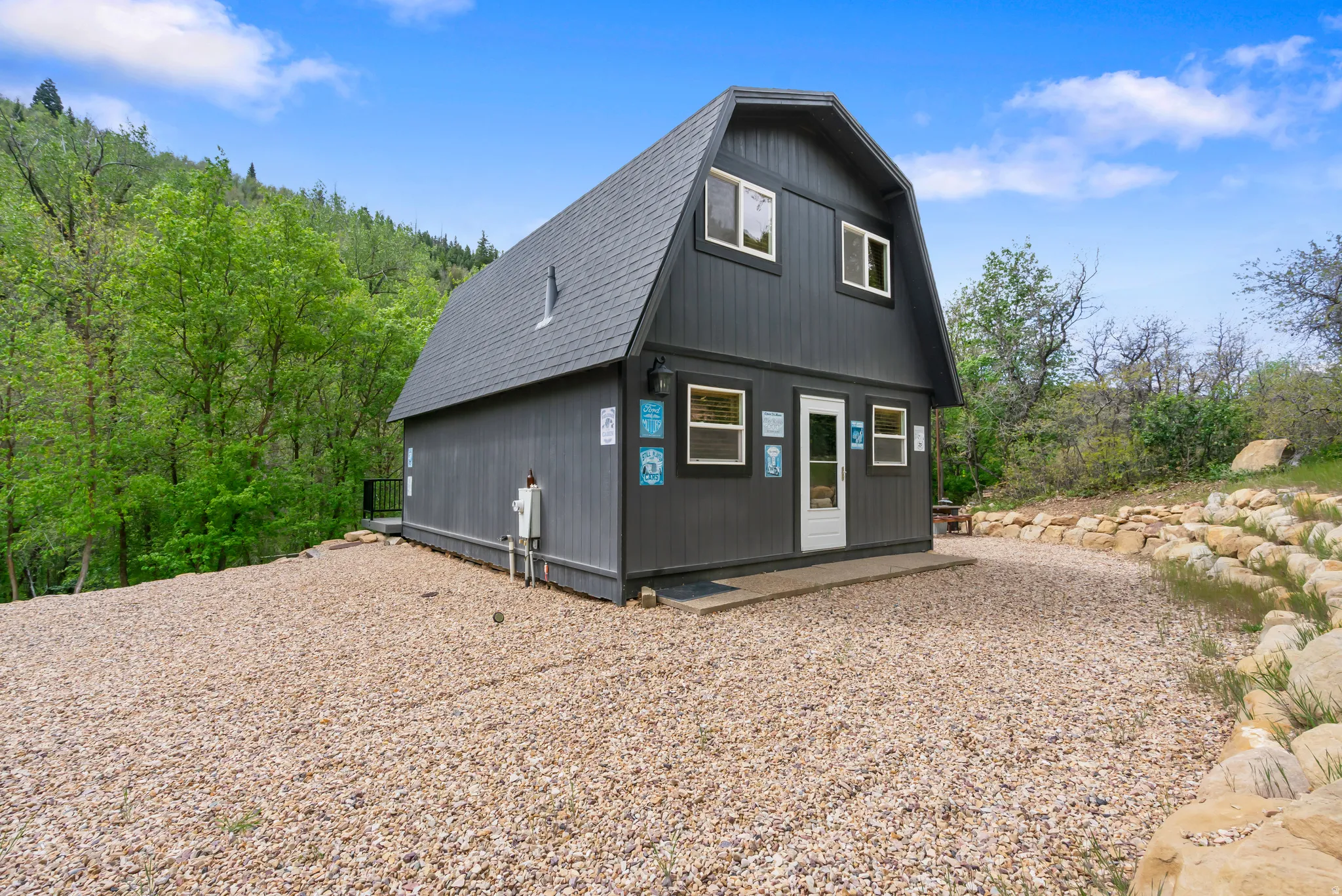 Gambrel-style exterior with dark vertical siding