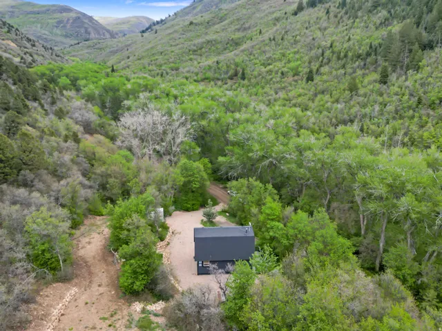 Compact modern structure nestled within a verdant mountain valley