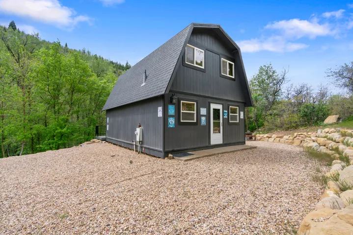 Gambrel-style exterior with dark vertical siding