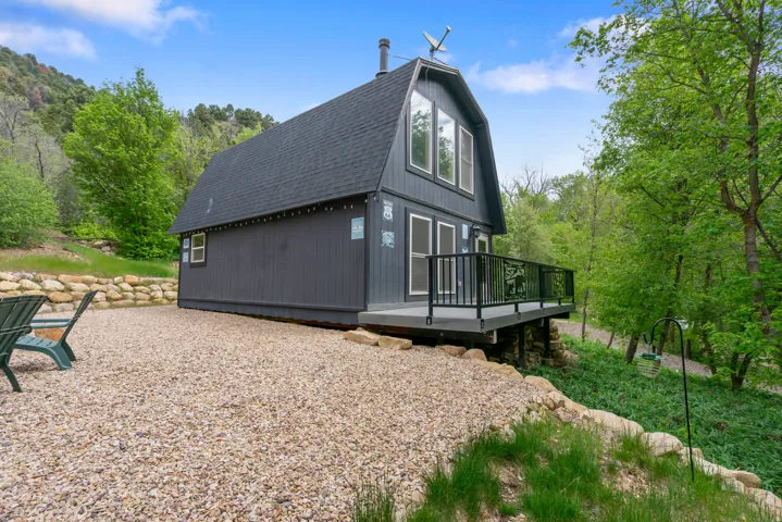 Barn-style exterior featuring dark siding, a gabled roof, and multiple upper-level windows