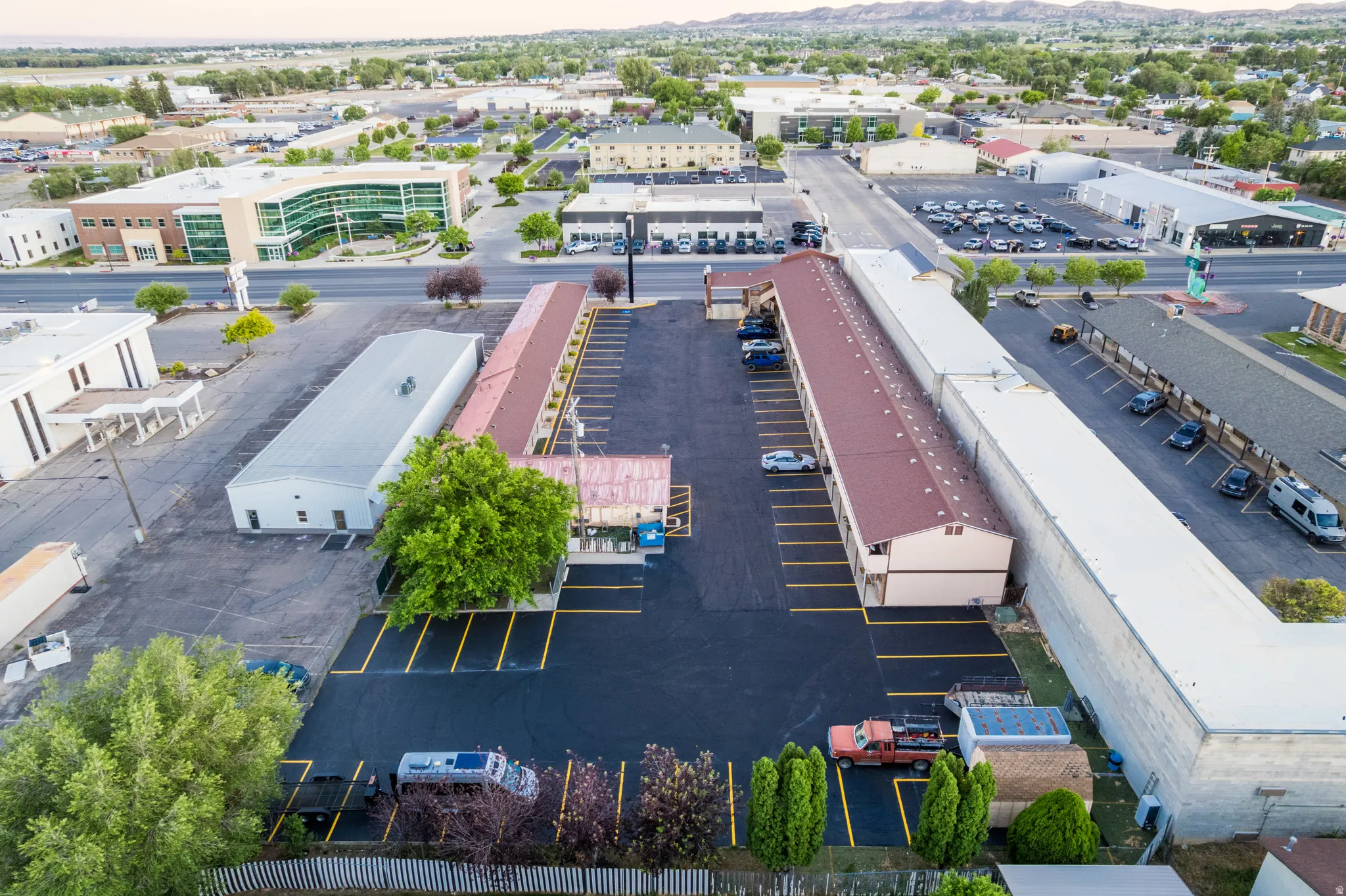 Aerial perspective showcasing multiple commercial structures and ample parking