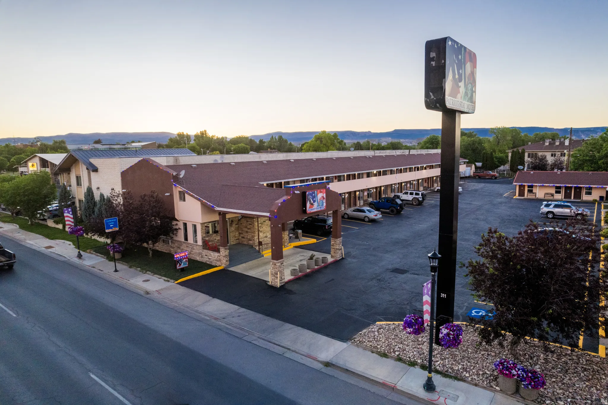 Multi-building commercial property featuring a main structure with a stone facade and covered entrance, along with additional single-story buildings