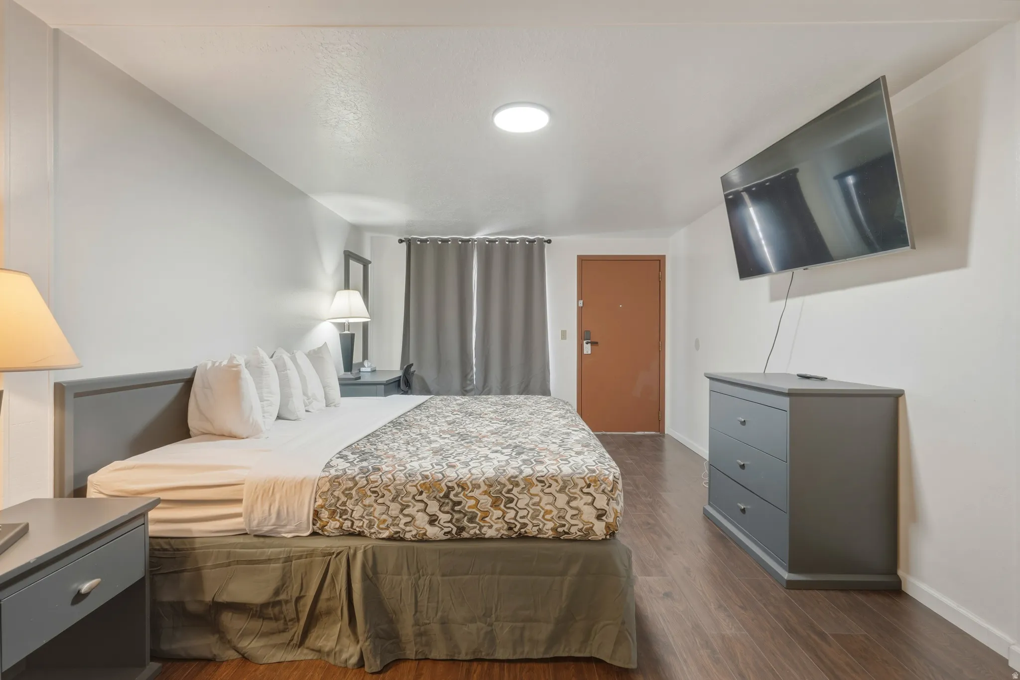 Bedroom featuring wood-finish flooring, white walls, and a recessed ceiling light