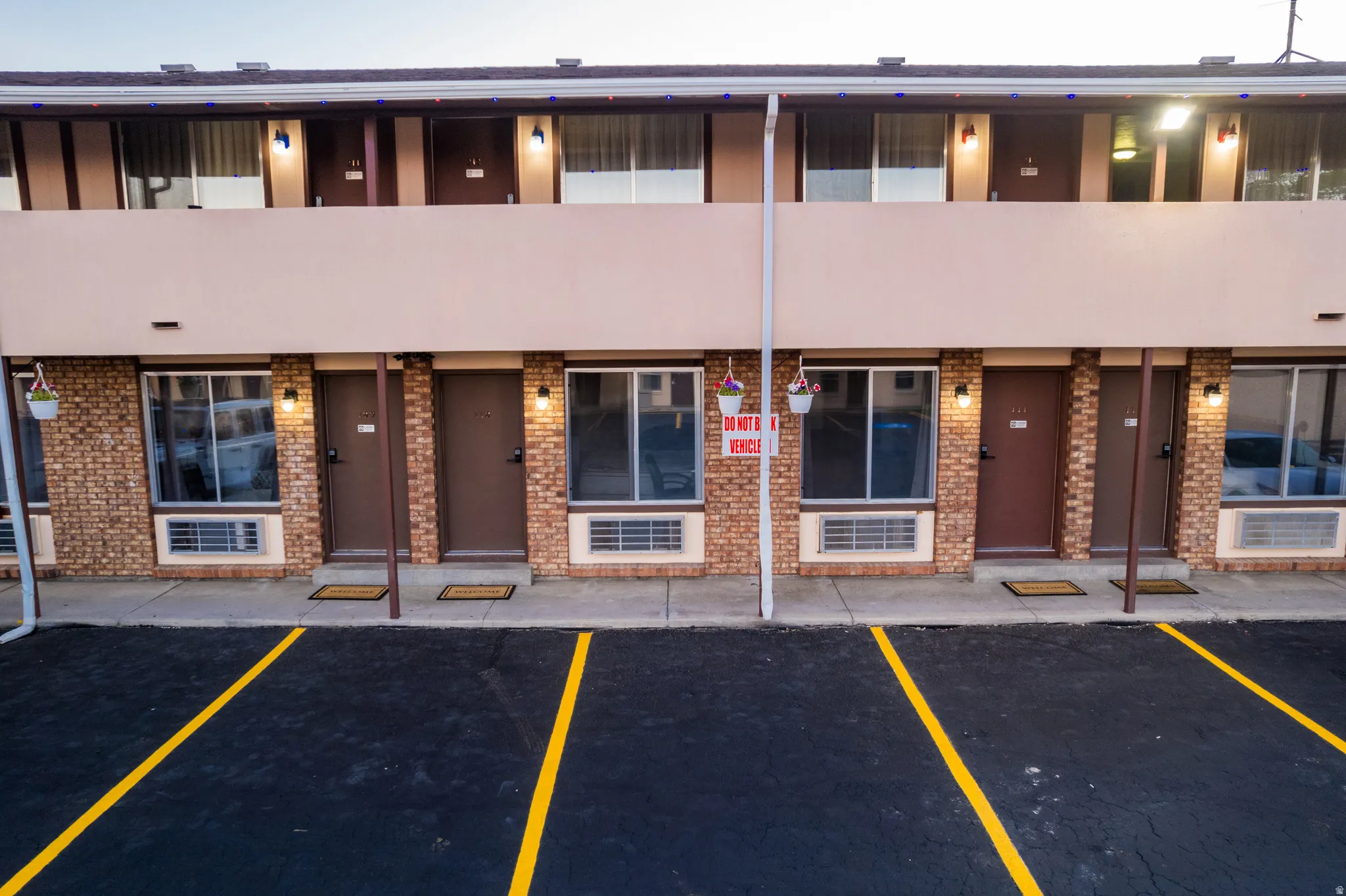 Brick and stucco facade with multiple entry doors and windows