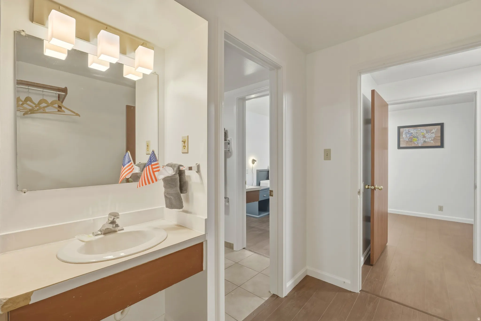 Bathroom vanity with an integrated sink and an overhead light fixture
