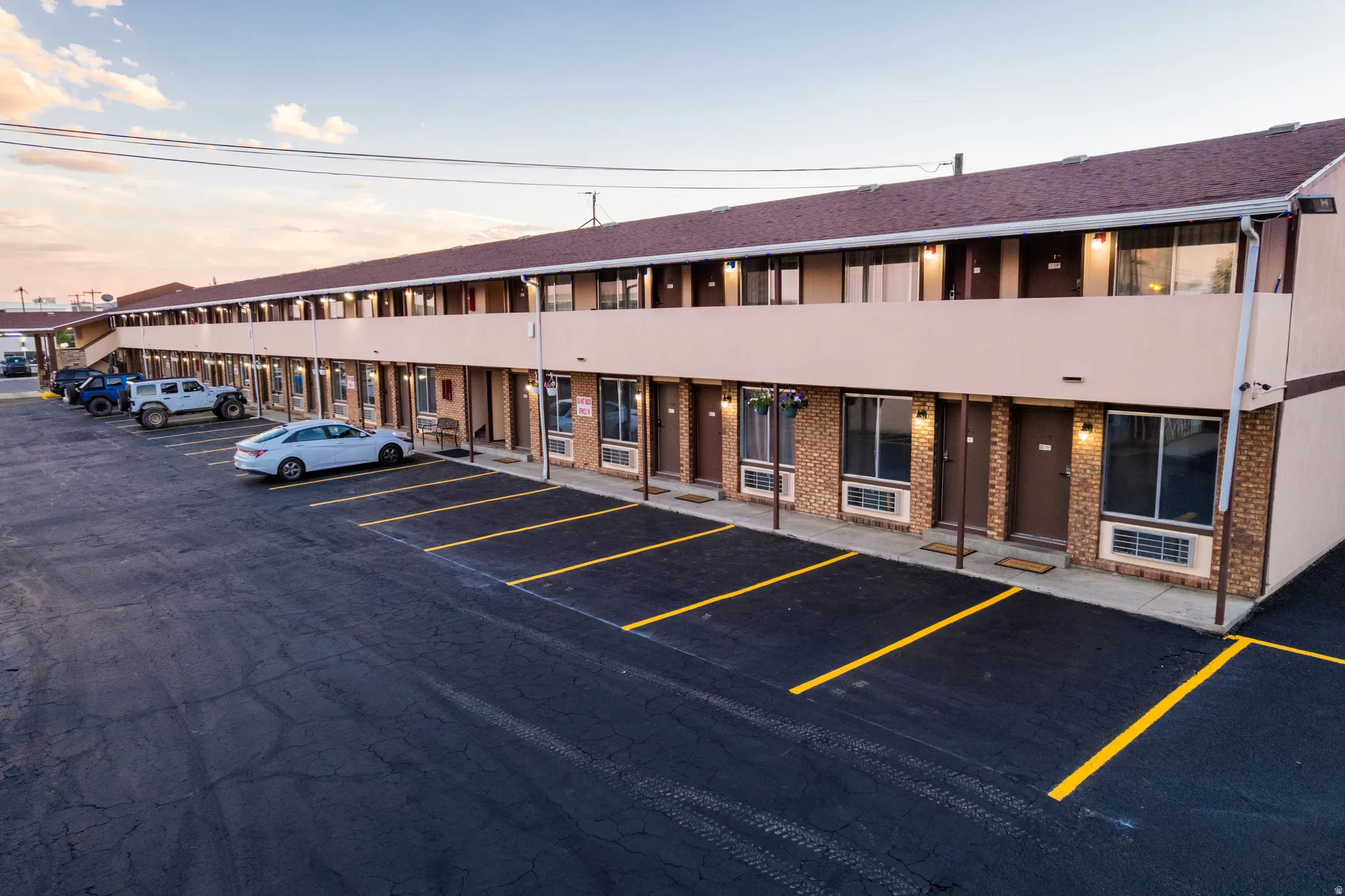 Two-story commercial building featuring multiple entryways and a brown shingle roof