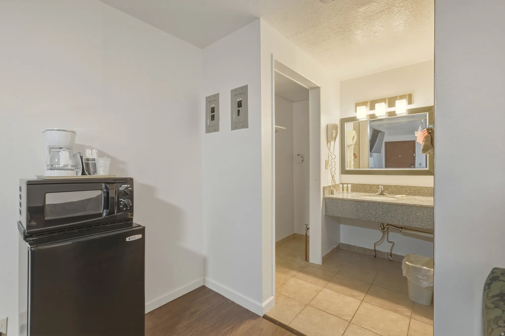 Kitchenette area featuring wood-finish flooring