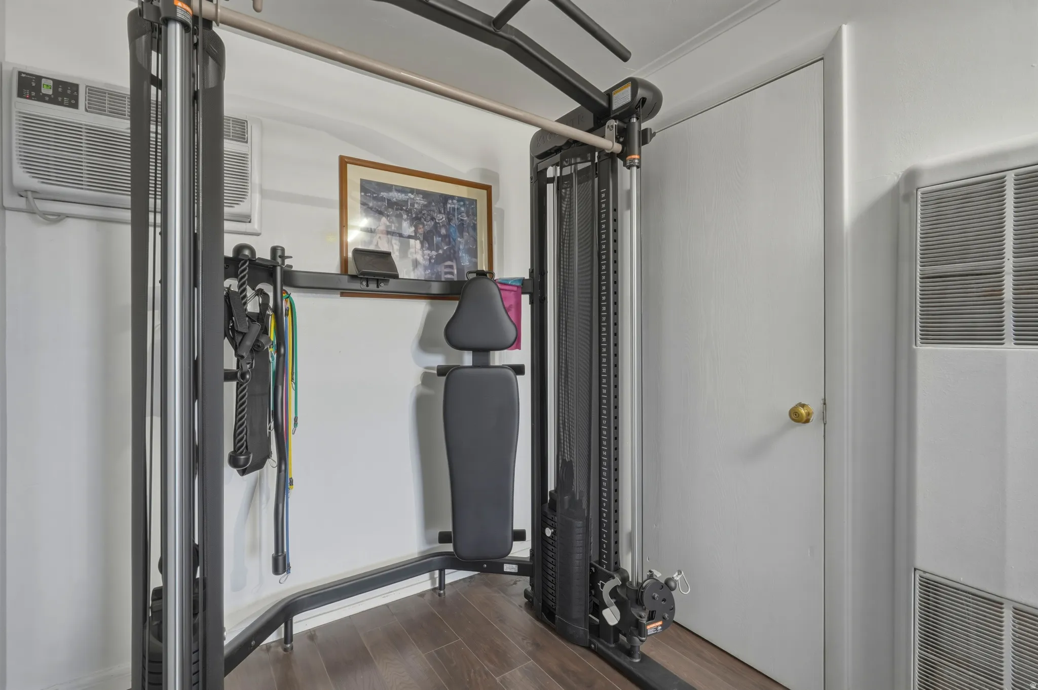 Dedicated room featuring wood-finish flooring and a white paneled door