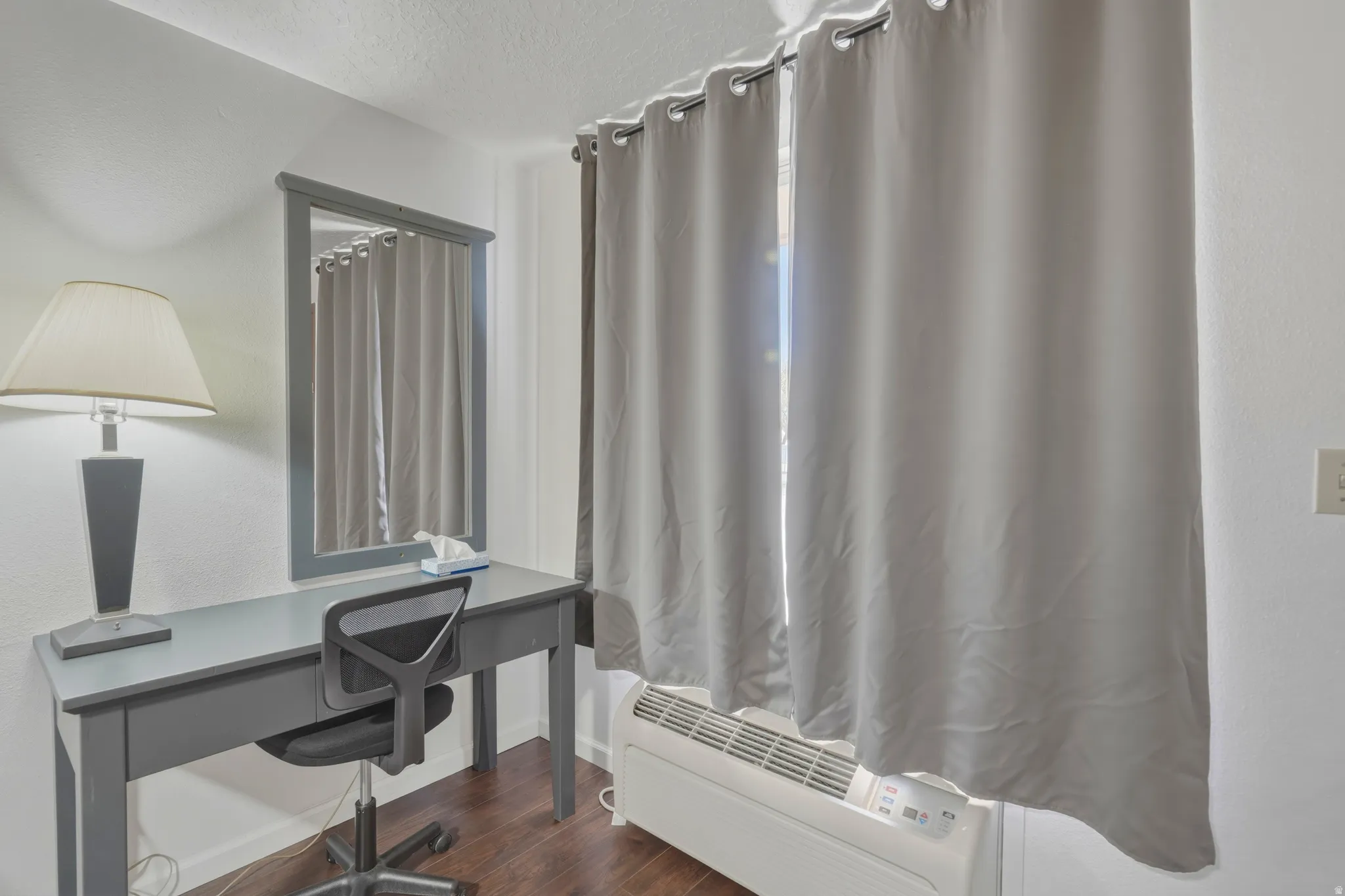 Dark wood-finish flooring complements the white walls