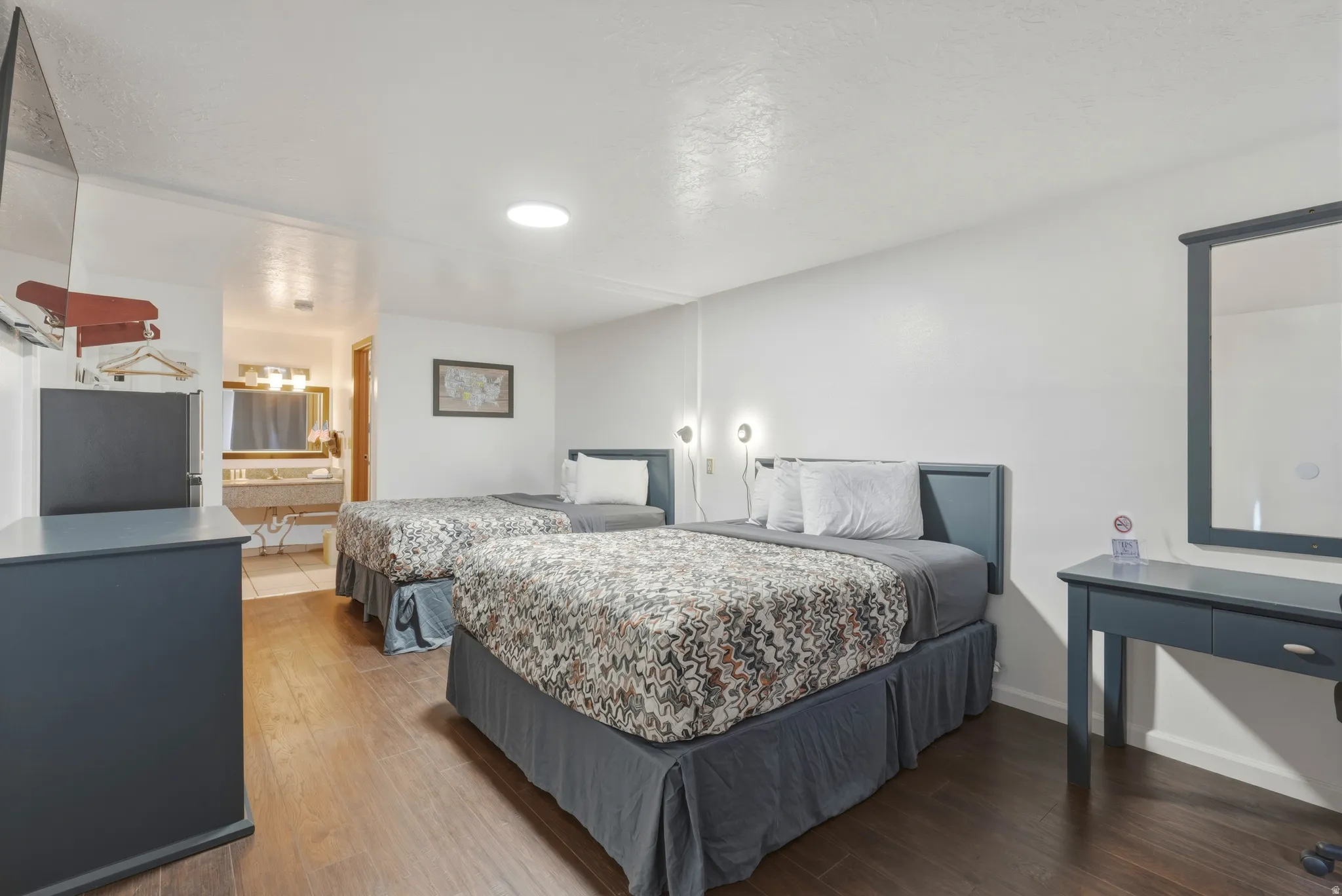 Bedroom featuring dark wood-finish flooring and white walls