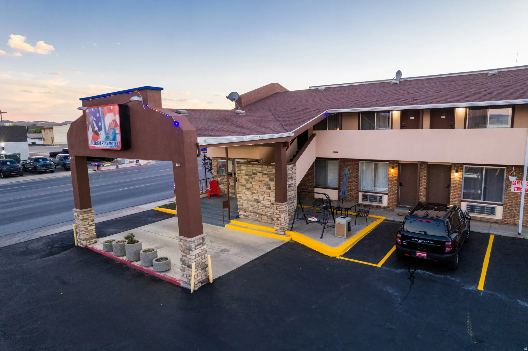 Two-story commercial building featuring a stone-clad entrance archway with integrated lighting