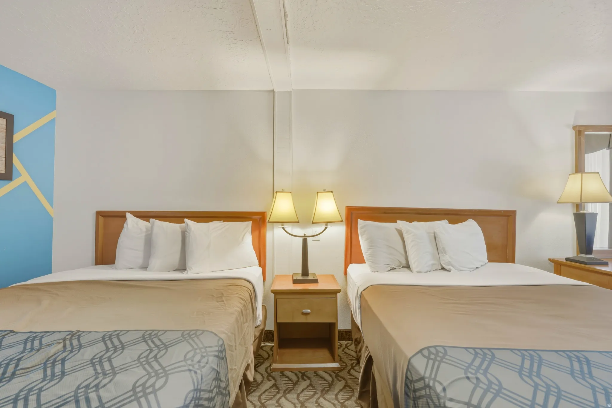 Bedroom featuring two beds with wood headboards