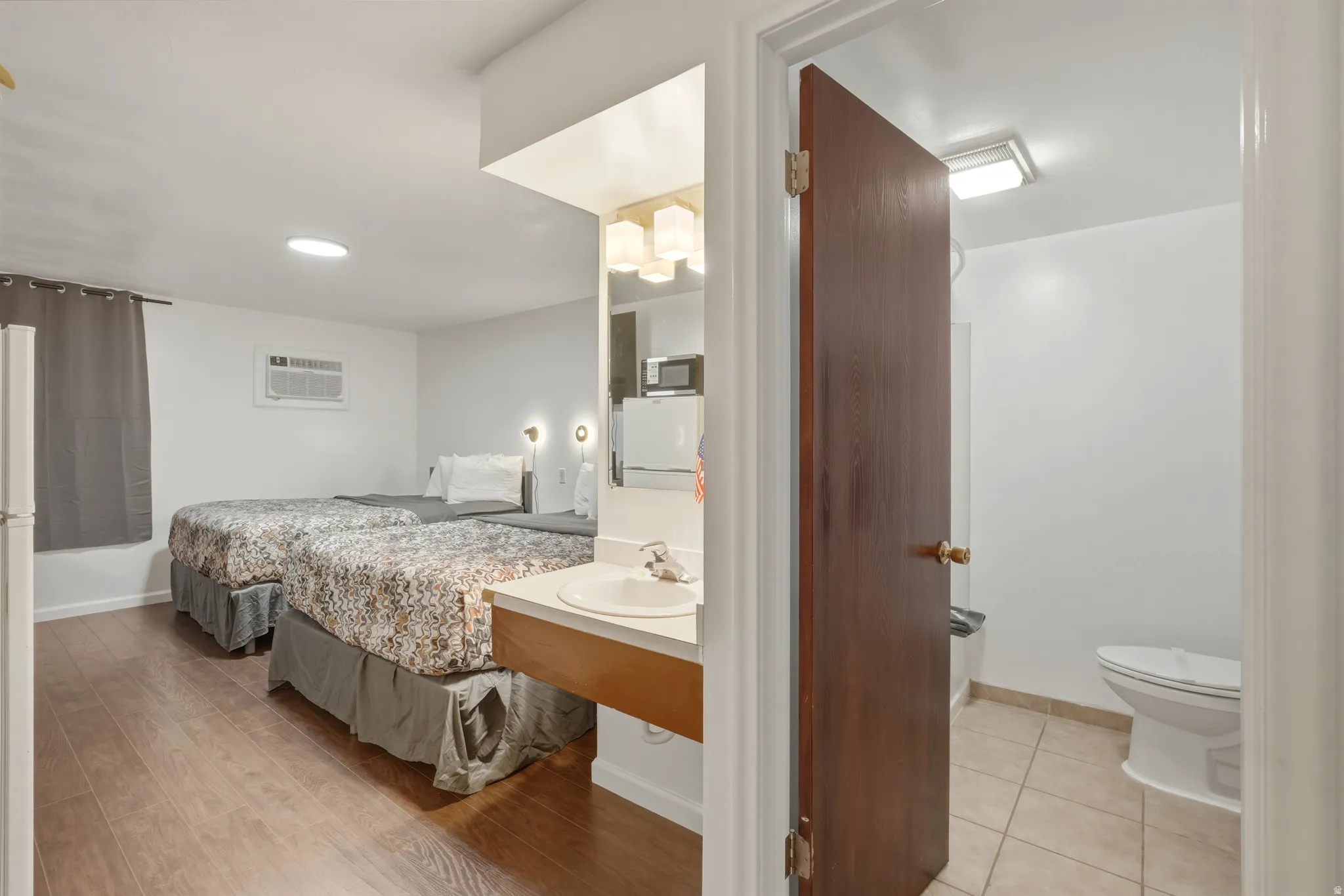 Open-concept room featuring wood-finish flooring and two integrated beds