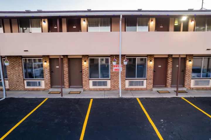 Brick and stucco facade with multiple entry doors and windows