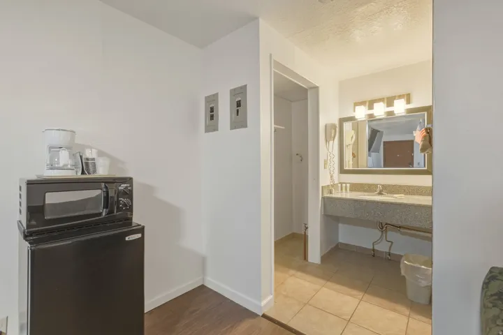 Kitchenette area featuring wood-finish flooring